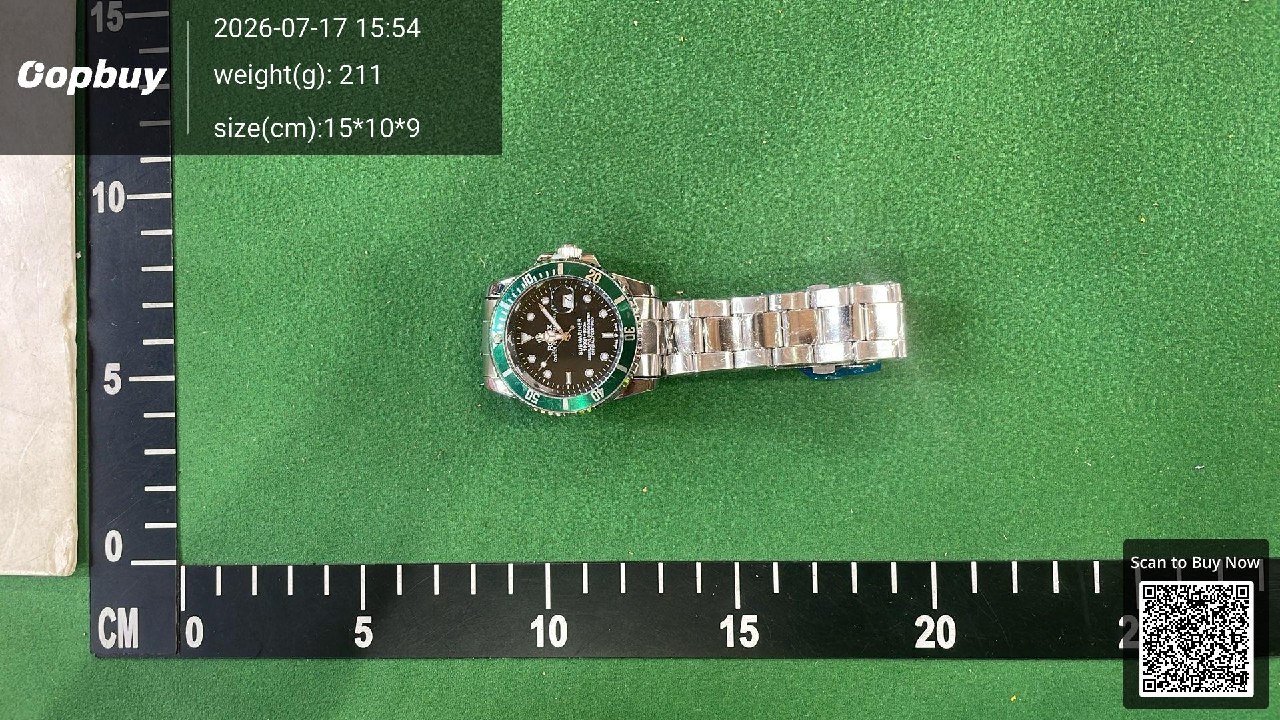 A metal bracelet watch viewed from above on a measuring mat