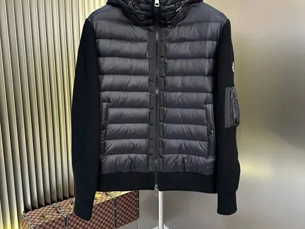 A dark padded jacket hanging in a seller product photograph